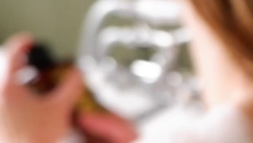 Blurred image of a person holding a Maze bottle with a blurred background