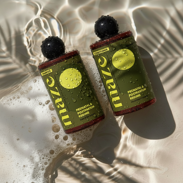 Two bottles of Maze prenatal and postpartum regime on a textured surface with water droplets.