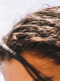 Close-up of a person's head with blurred hair and skin