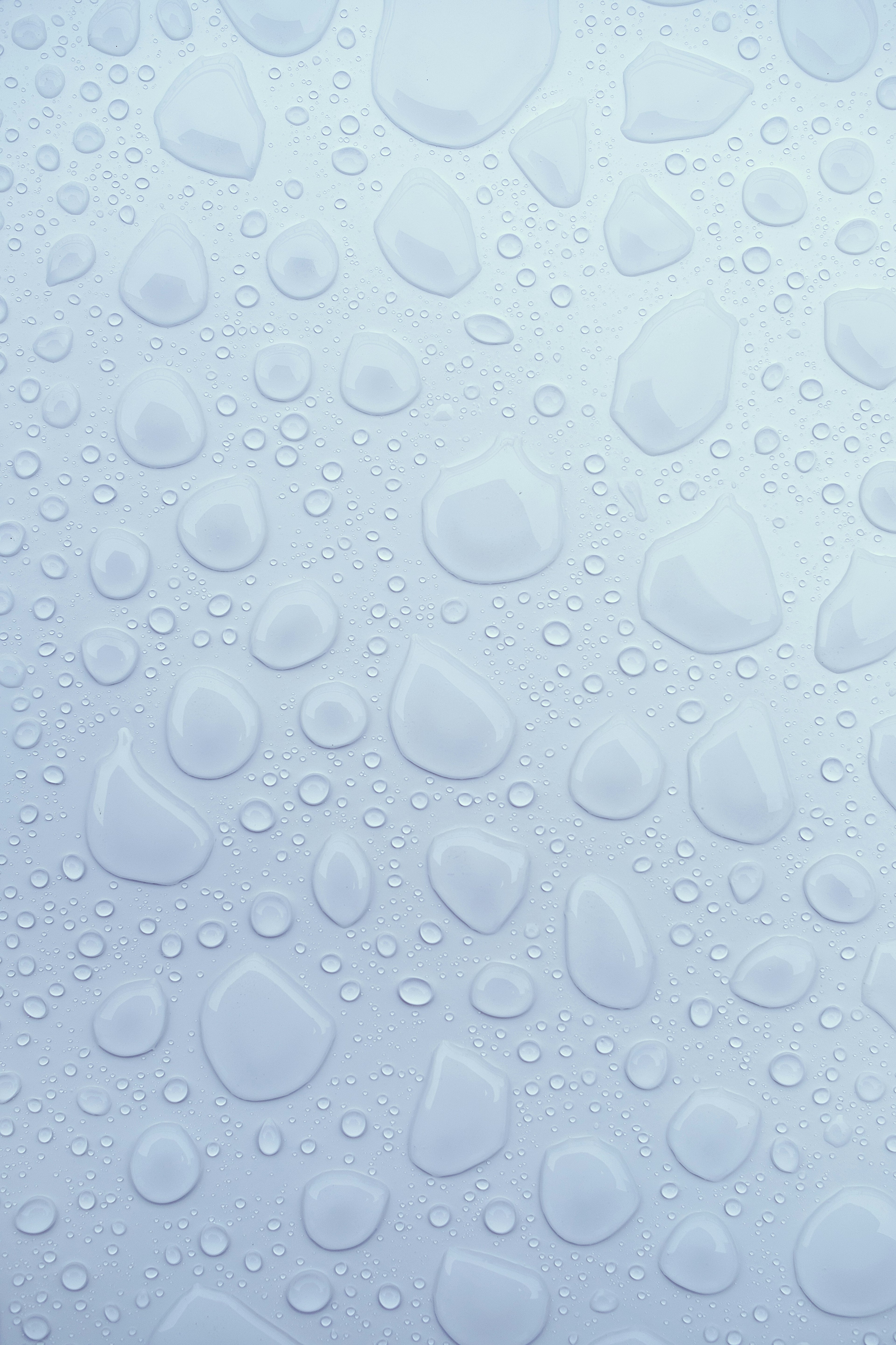Pattern of water droplets on a light blue surface