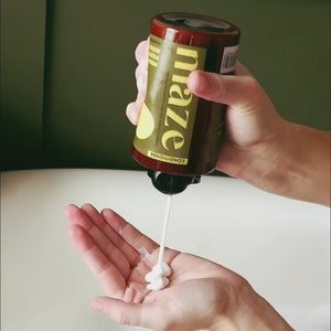 Conditioner being squeezed out of Maze bottle